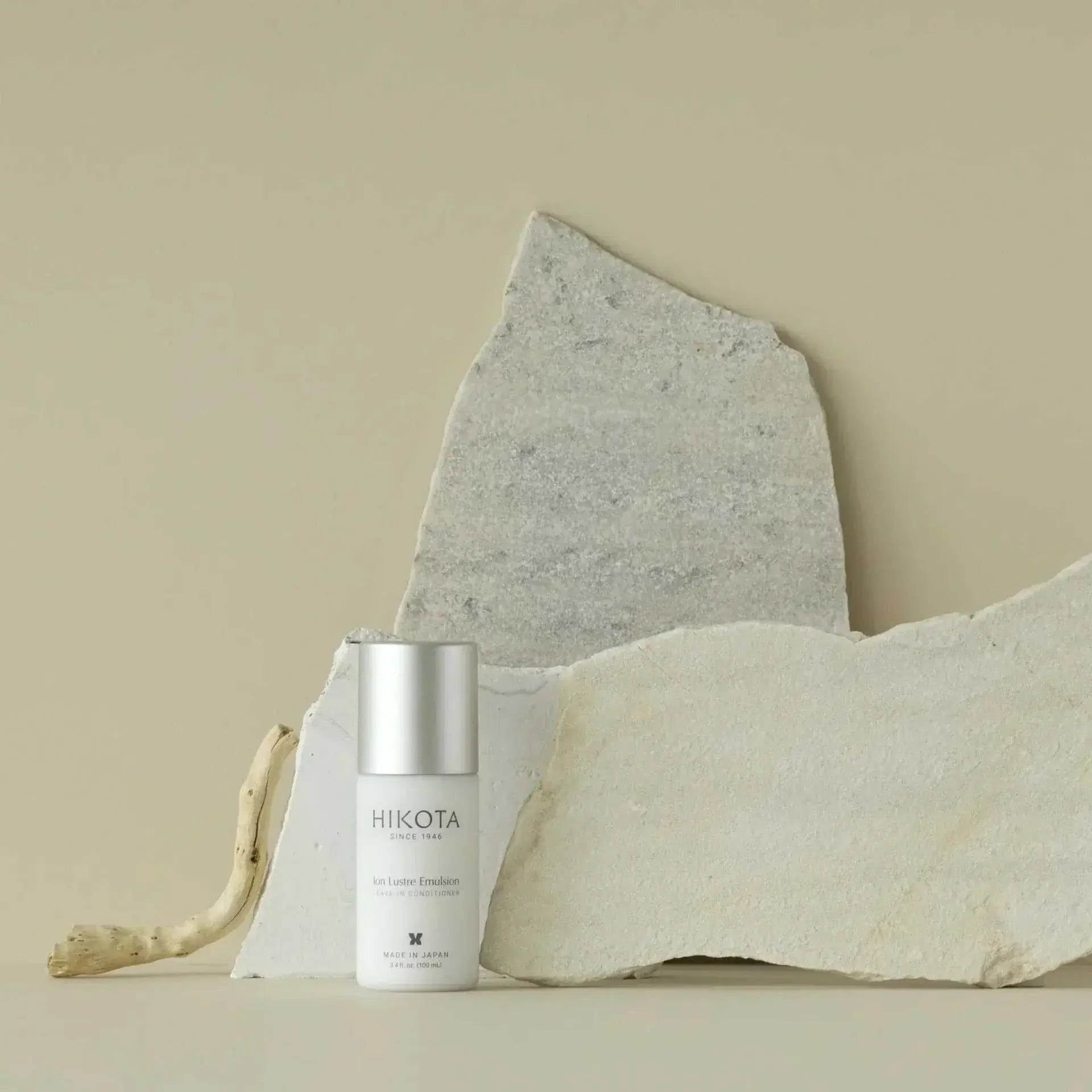 Ion Lustre Emulsion Leave in Hair Treatment for damaged and dry hair, elegantly displayed with a minimalist backdrop.