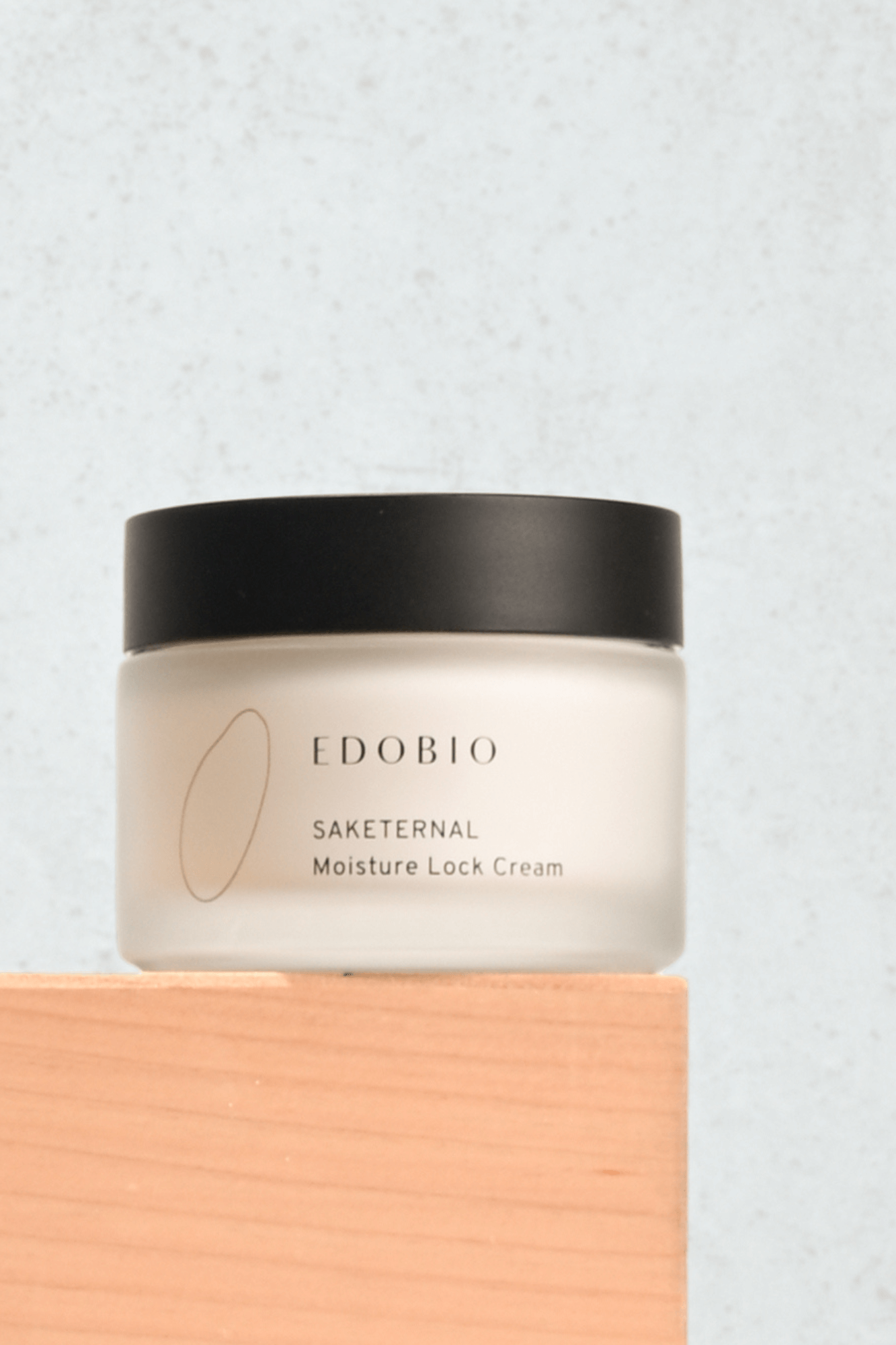Moisture Lock Cream in a clear jar with a black lid, formulated for smooth, even complexion.