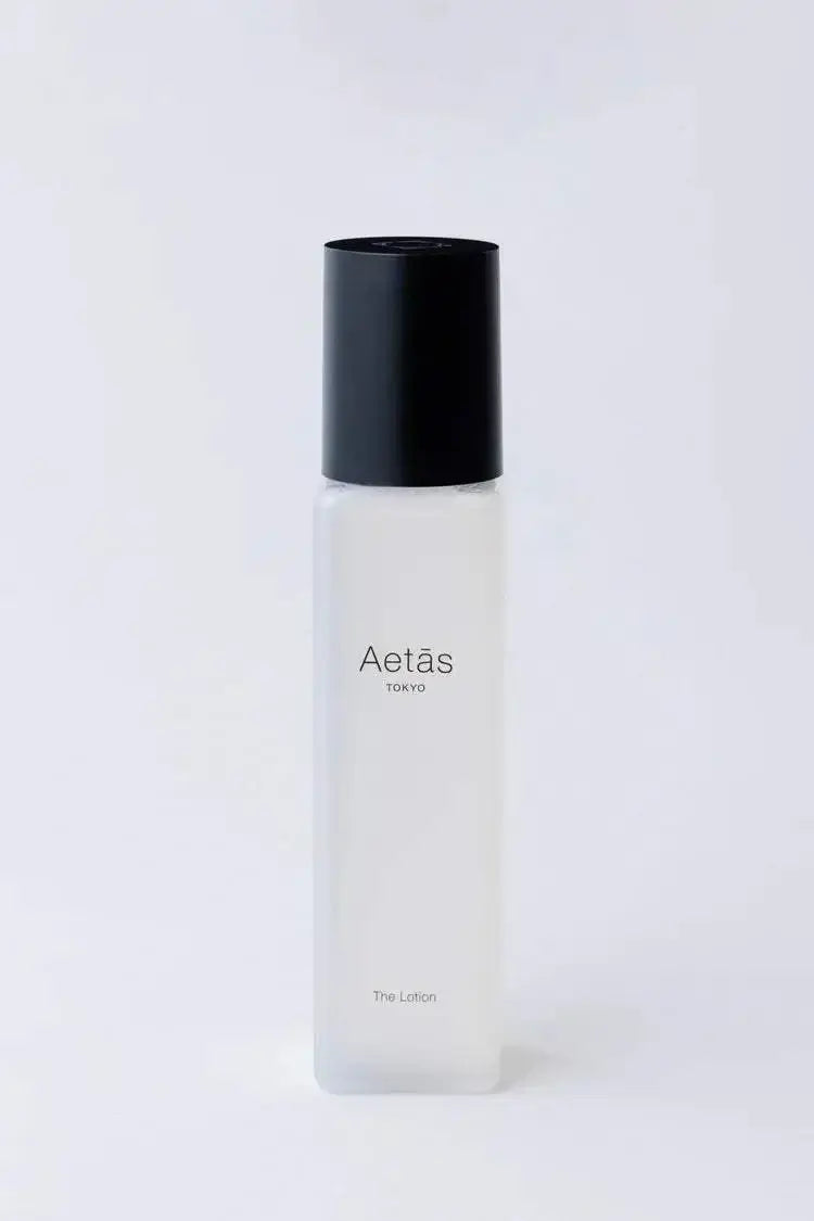 Aetas The Face Lotion in sleek white bottle with black cap.