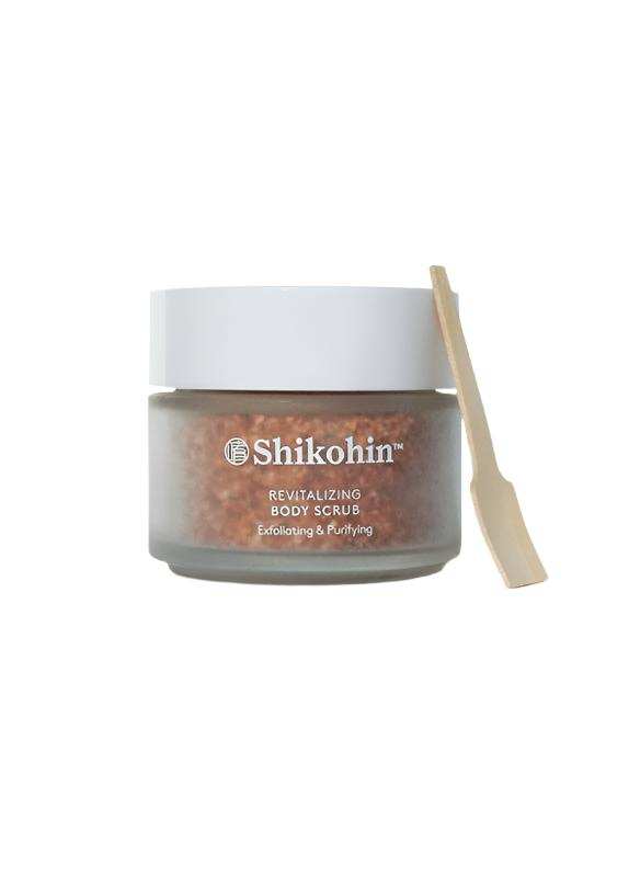 Shikohin Hemp & Rice Body Scrub in clear jar with wooden spatula.