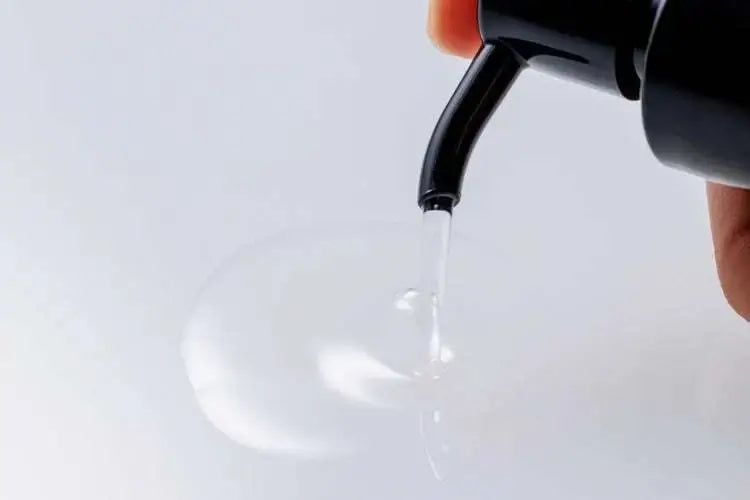 The Cleanser being dispensed from a pump, featuring a clear liquid formula.