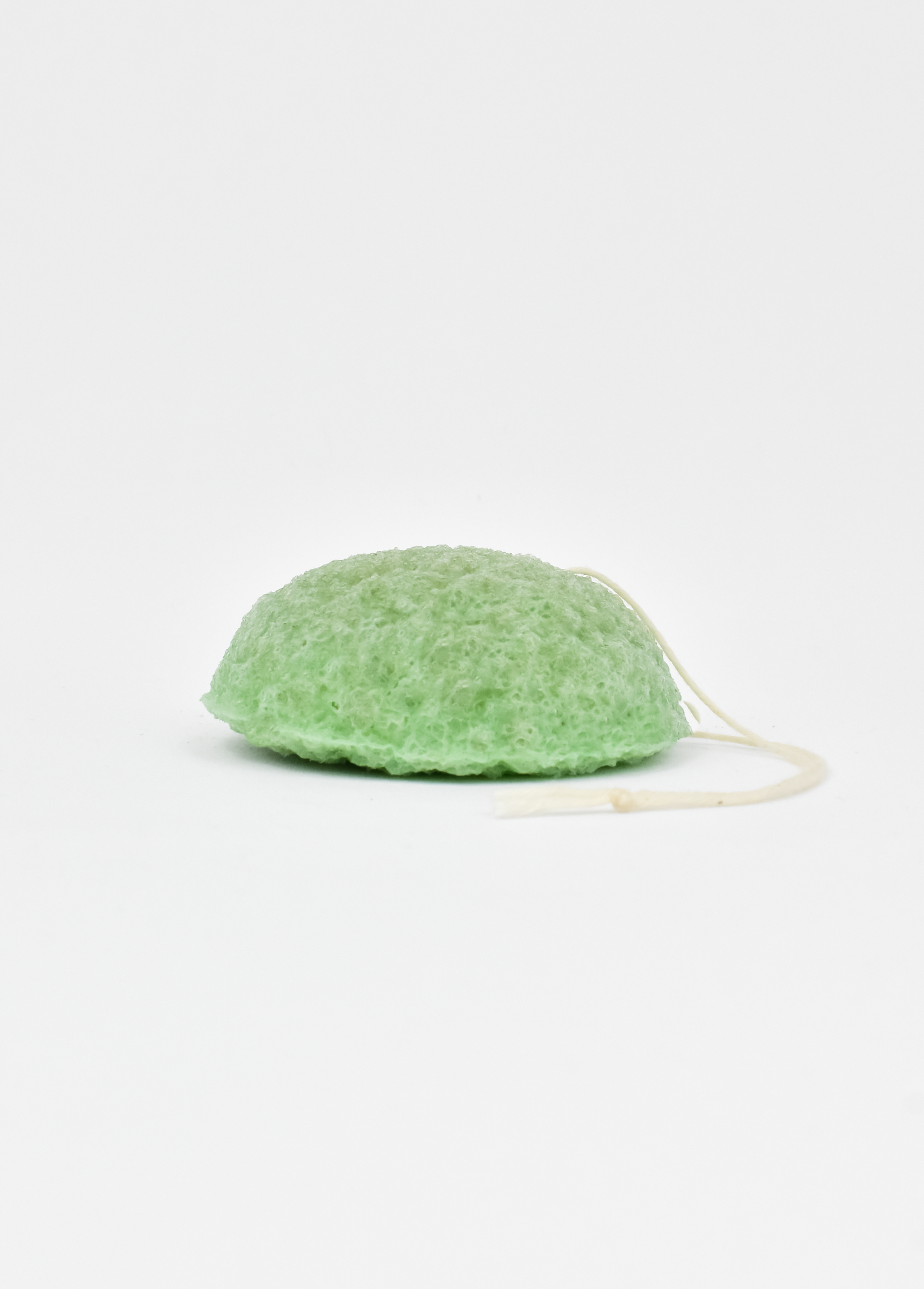 Shikohin Plant-Based Konjac Sponge in green color for gentle exfoliation and skin balance.