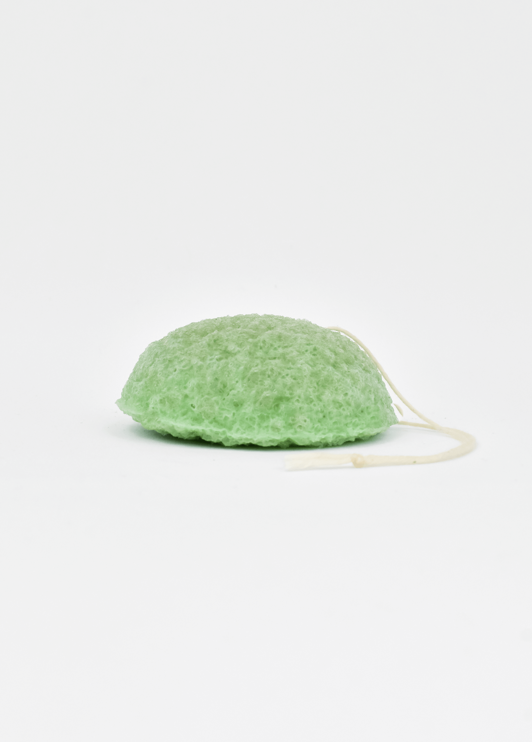 Shikohin Plant-Based Konjac Sponge in green color for gentle exfoliation and skin balance.