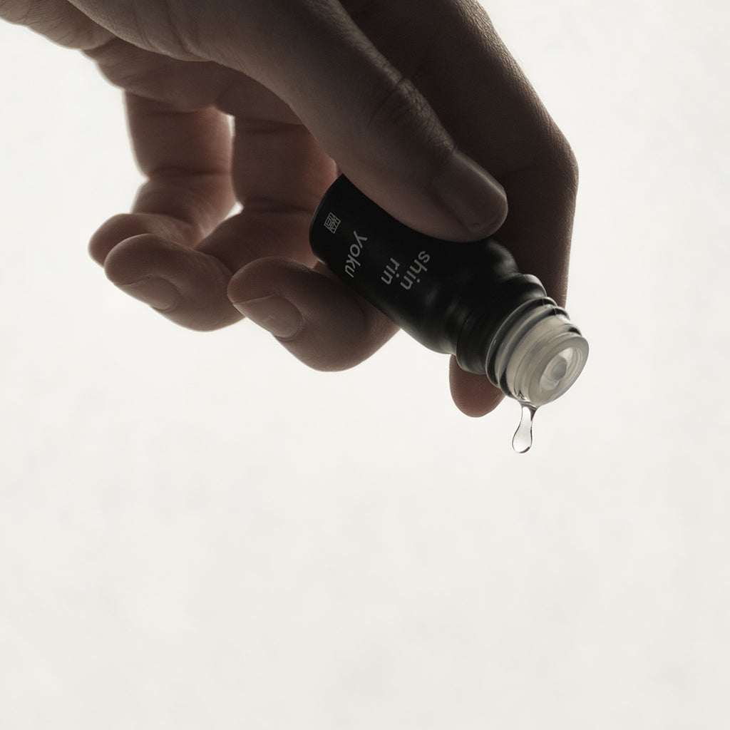 Hand pouring Shin Rin Yoku Hinoki Essential Oil PM made from hinoki leaf and pure water from Hinohata Village, Tokyo.