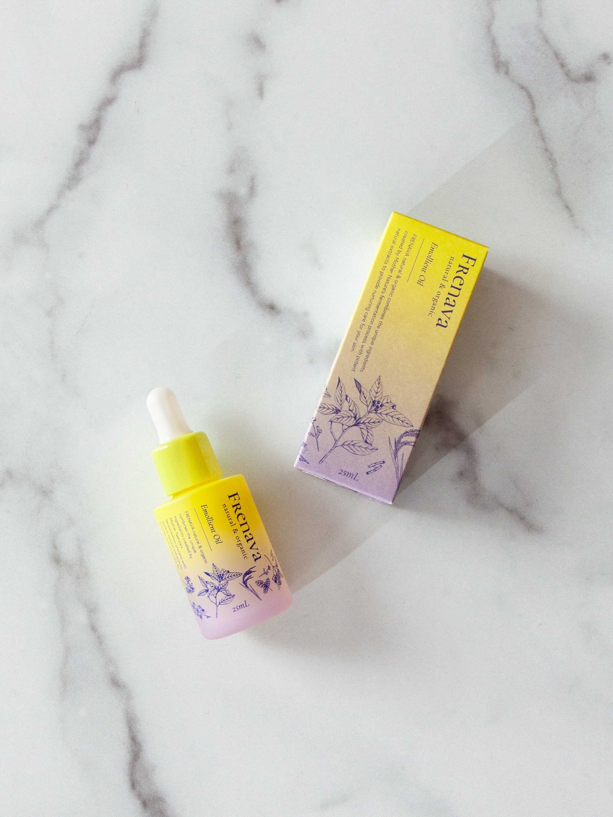 Frenava Emollient Oil with sake lees extract and Squalane on marble surface.