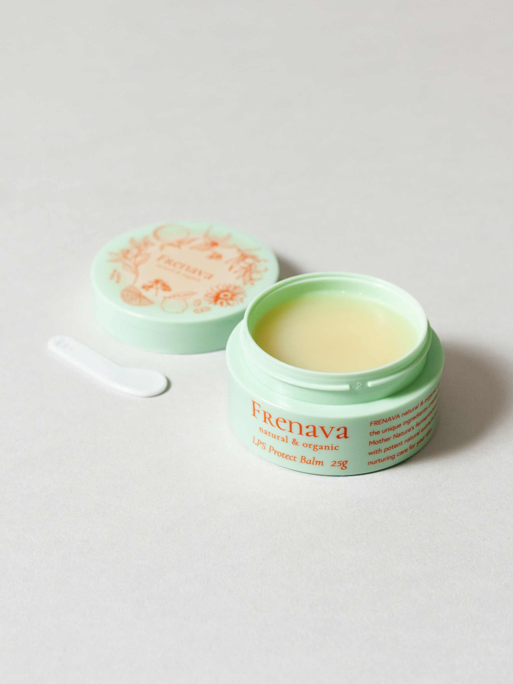 Frenava LPS Protect Balm in mint green jar with lid and applicator, offering cedar-scented skin protection.