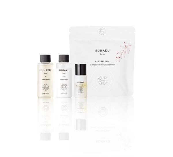 Ruhaku Hair Travel Set with Thalasso Shampoo, Treatment, and Scalp & Hair Oil in a portable pouch.