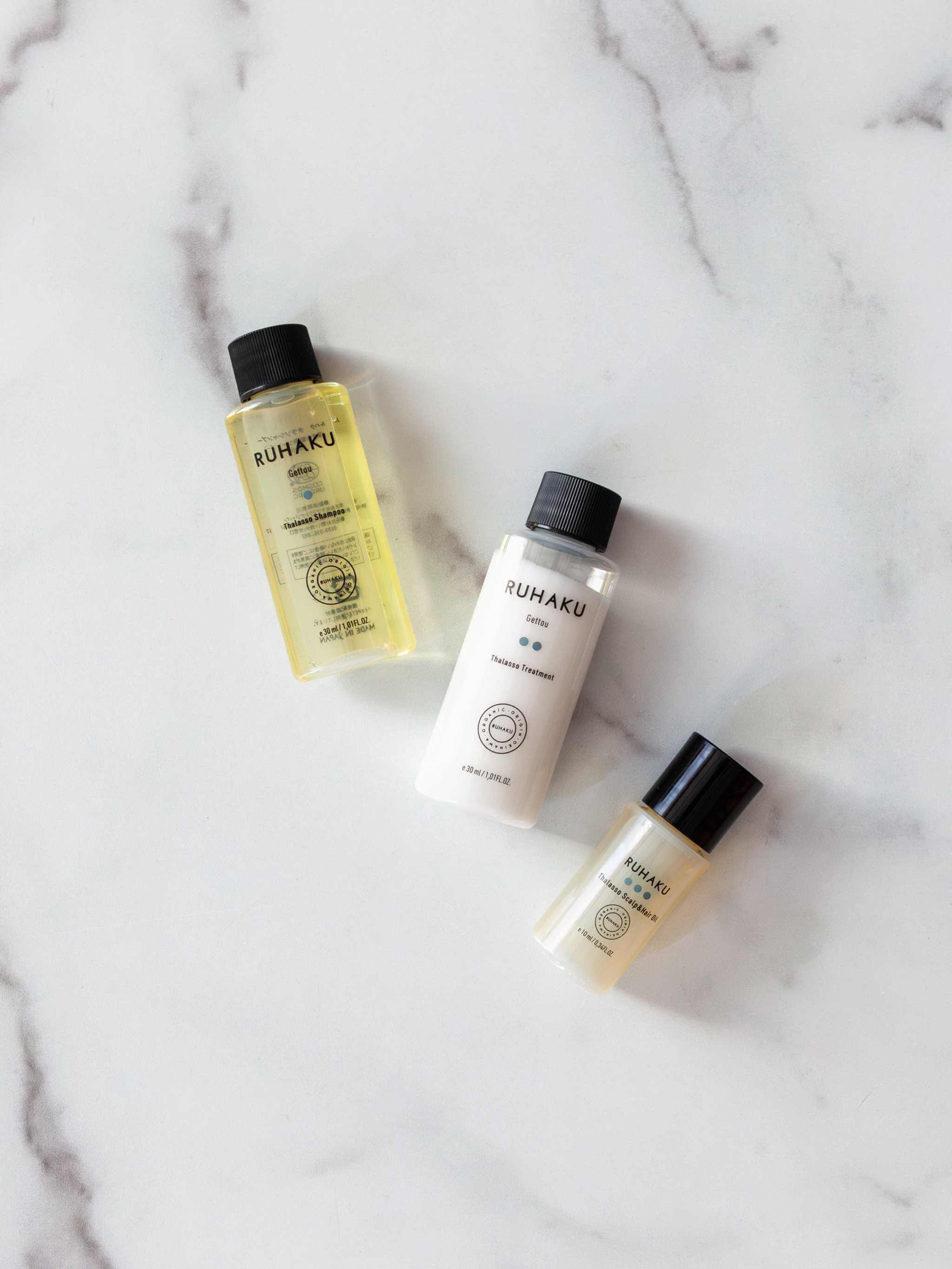 Ruhaku Hair Travel Set with shampoo, treatment, and scalp oil.