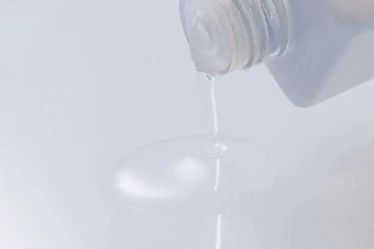 Aetas The Face Lotion being poured from a bottle, showcasing its smooth texture.