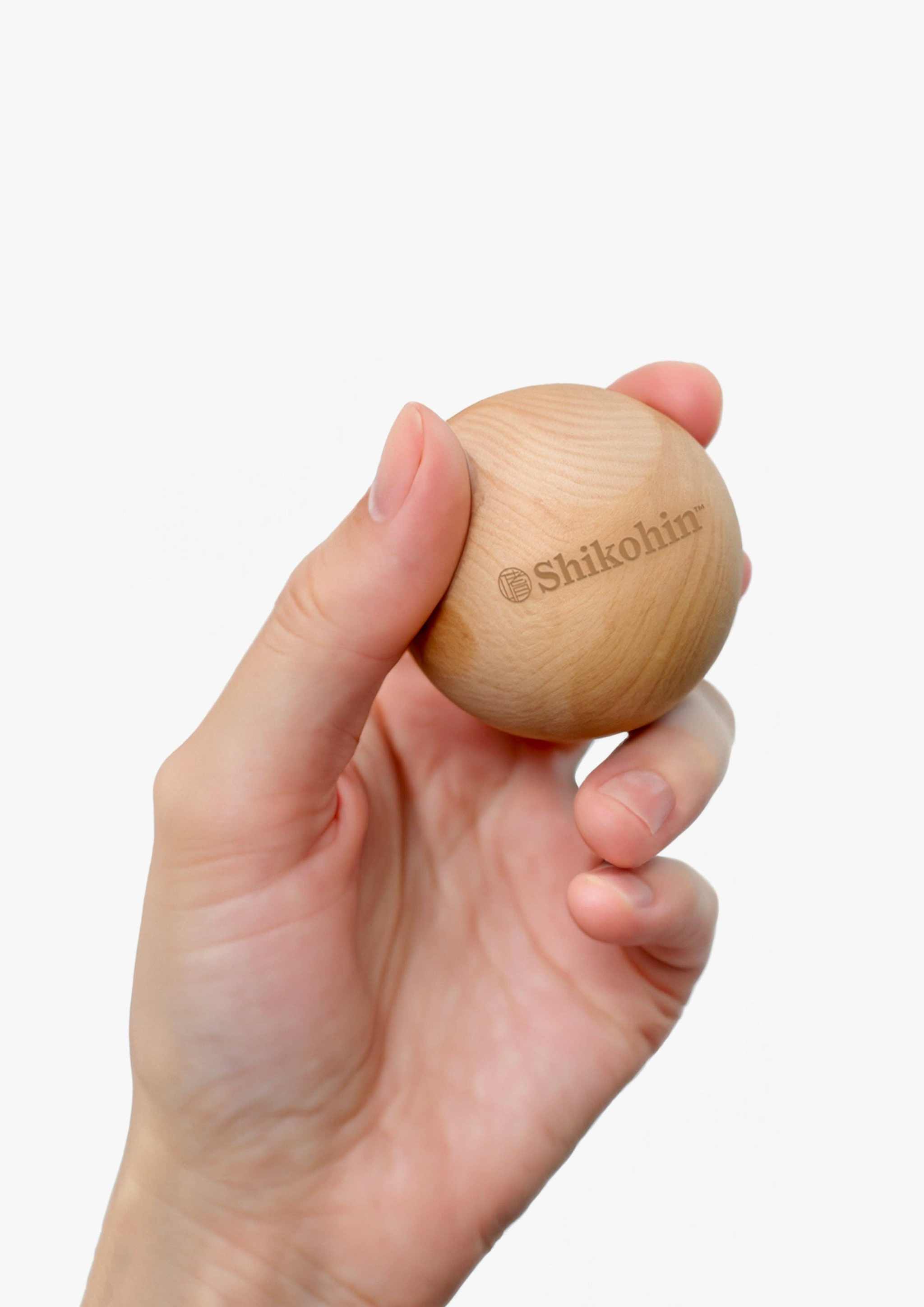 Hinoki Bath Balls 3 pc held in hand, showcasing natural wood texture.
