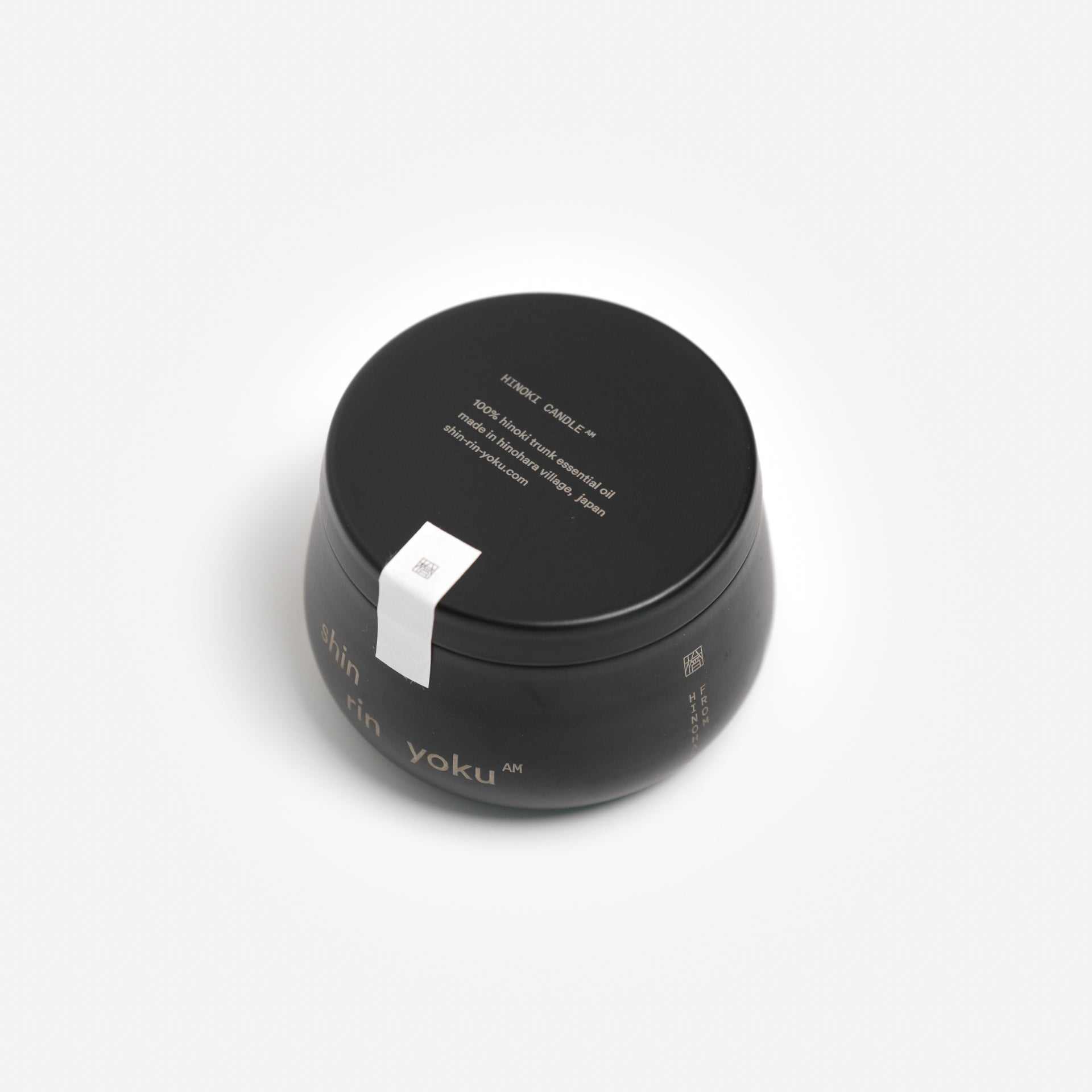 Hinoki Candle AM with natural hinoki trunk oil packaging.