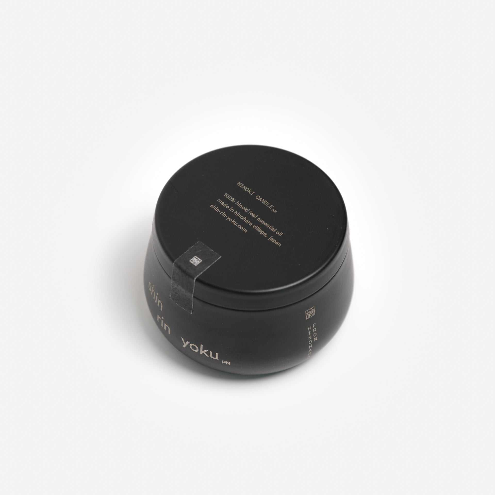 Hinoki Candle PM in black jar with minimalist design, featuring hinoki leaf essential oil.