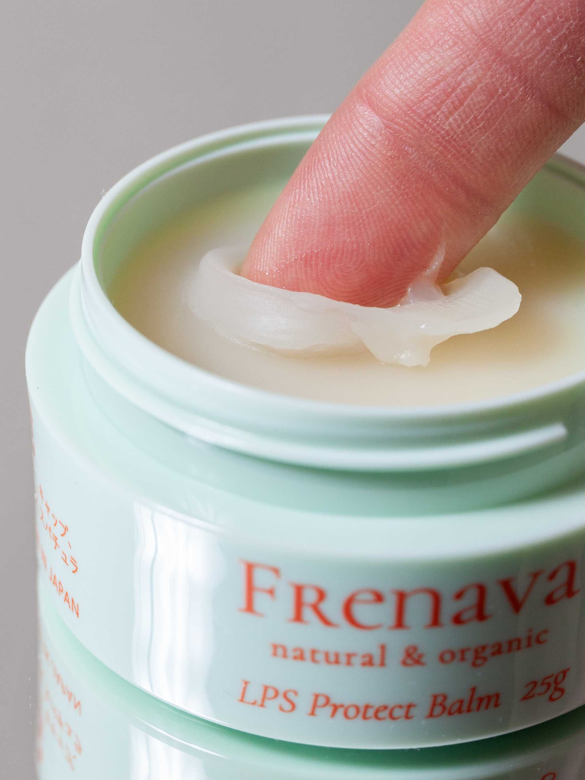 Frenava LPS Protect Balm in jar with a finger applying the balm for skin protection.