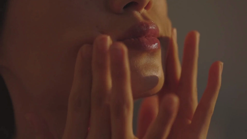 video of woman applying skincare products, followed by a scene of Japanese forest and a female meditating, and a scene of a flowing river.